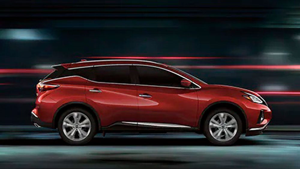 2023 Nissan Murano shown in profile driving down a street at night illustrating performance. | Coughlin Nissan of Heath in Heath OH