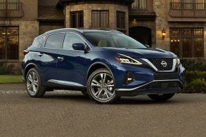 Dark blue 2022 Nissan Murano parked in front of a bricked house.