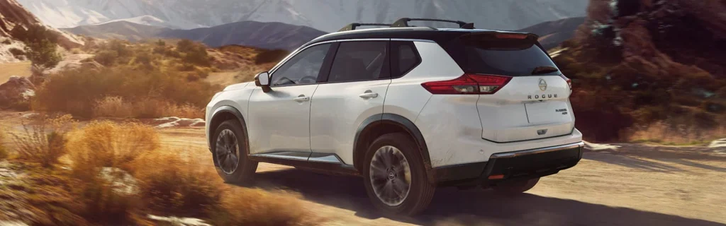 White Nissan Rogue off-road desert drive